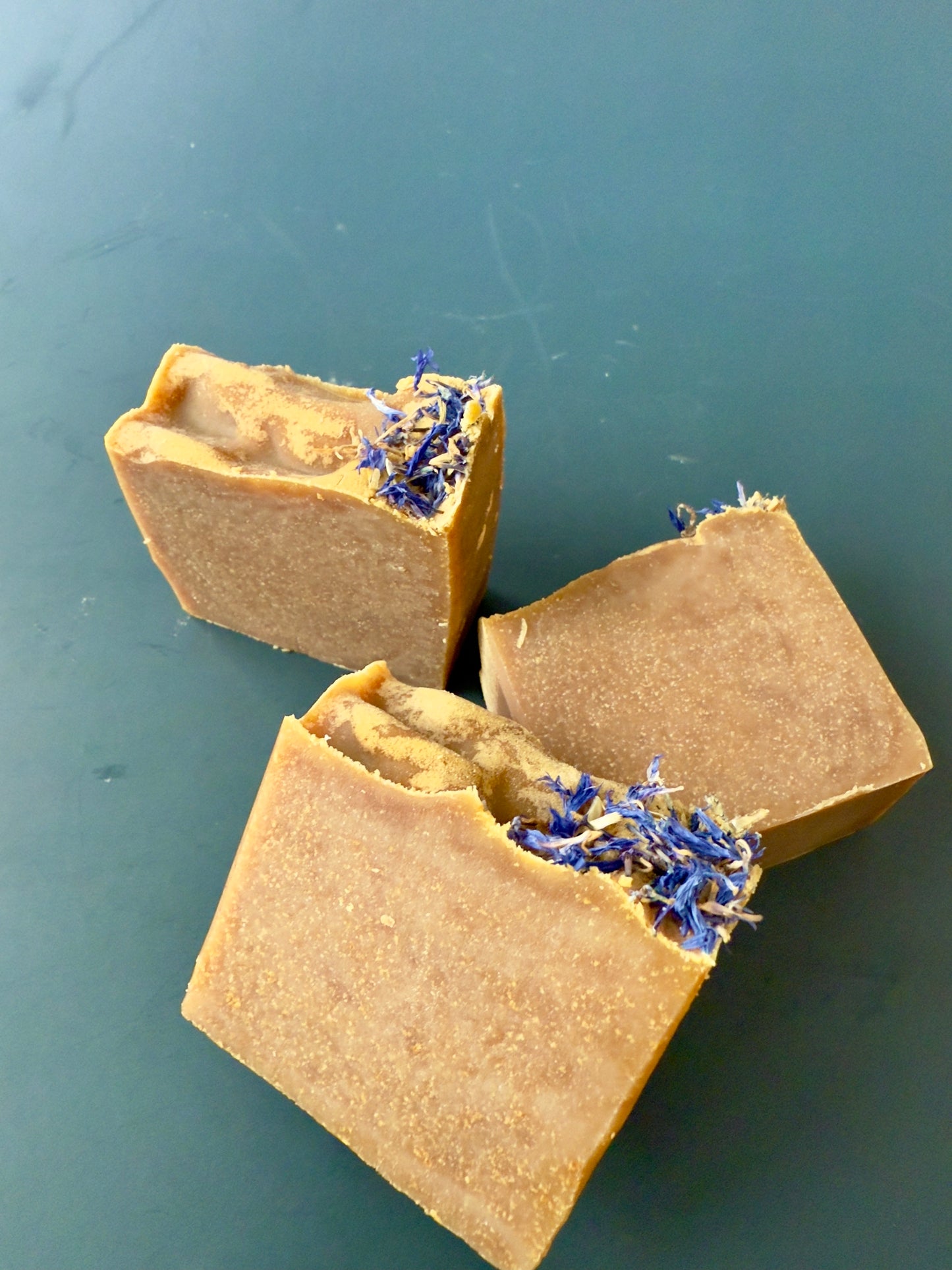 Blue Butterfly cold process soap with cornflower petals on top, shown in large and small bar sizes.