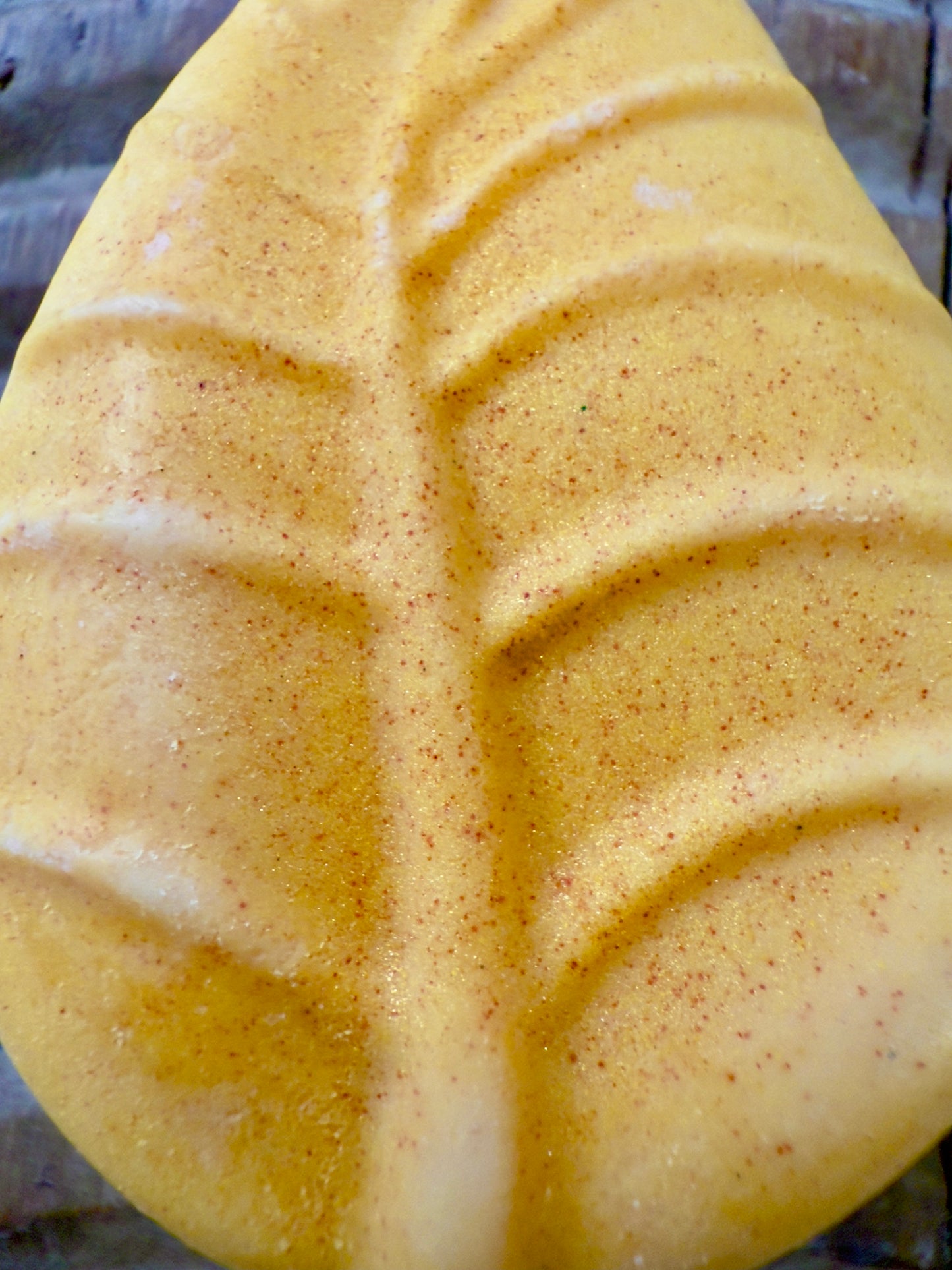 “Banana Pineapple solid shampoo bar in yellow leaf shape with subtle shimmer”
