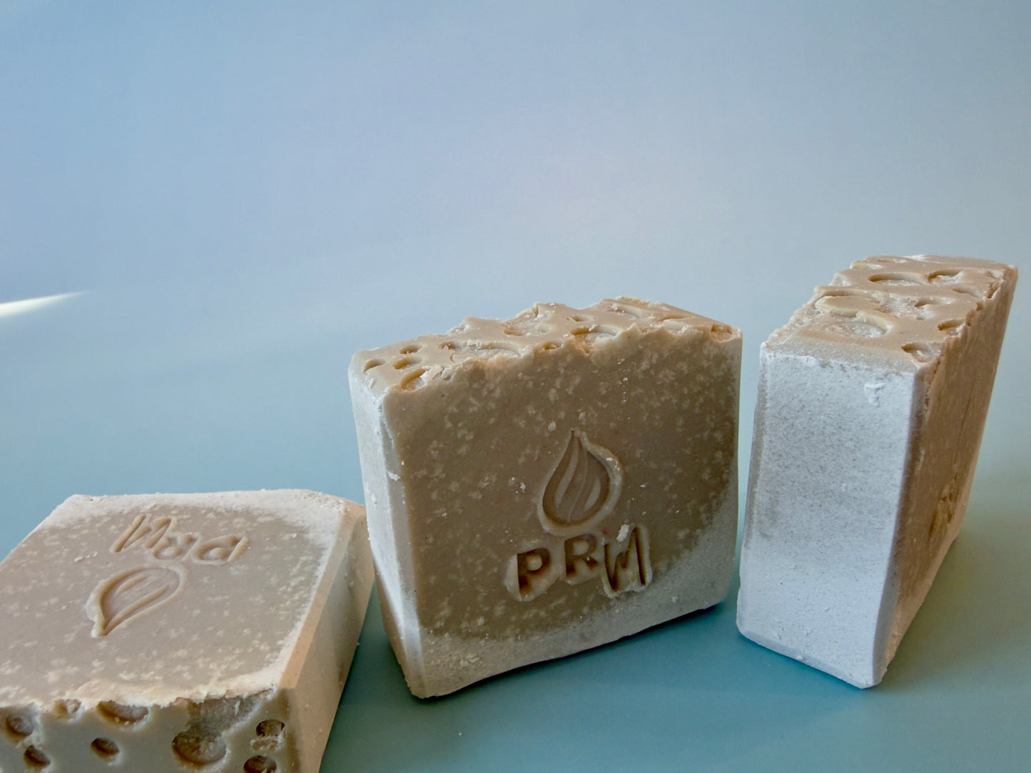 Close-up of Ocean Mist soap bars showing natural clay variation and PRM stamp