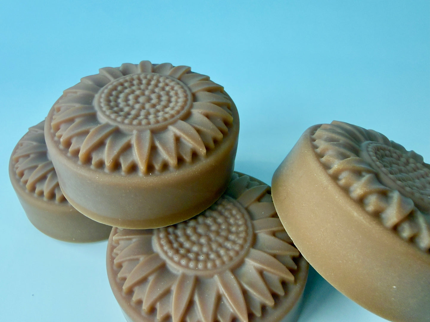 Stacked sunflower dish soaps showing thickness and molded floral pattern
