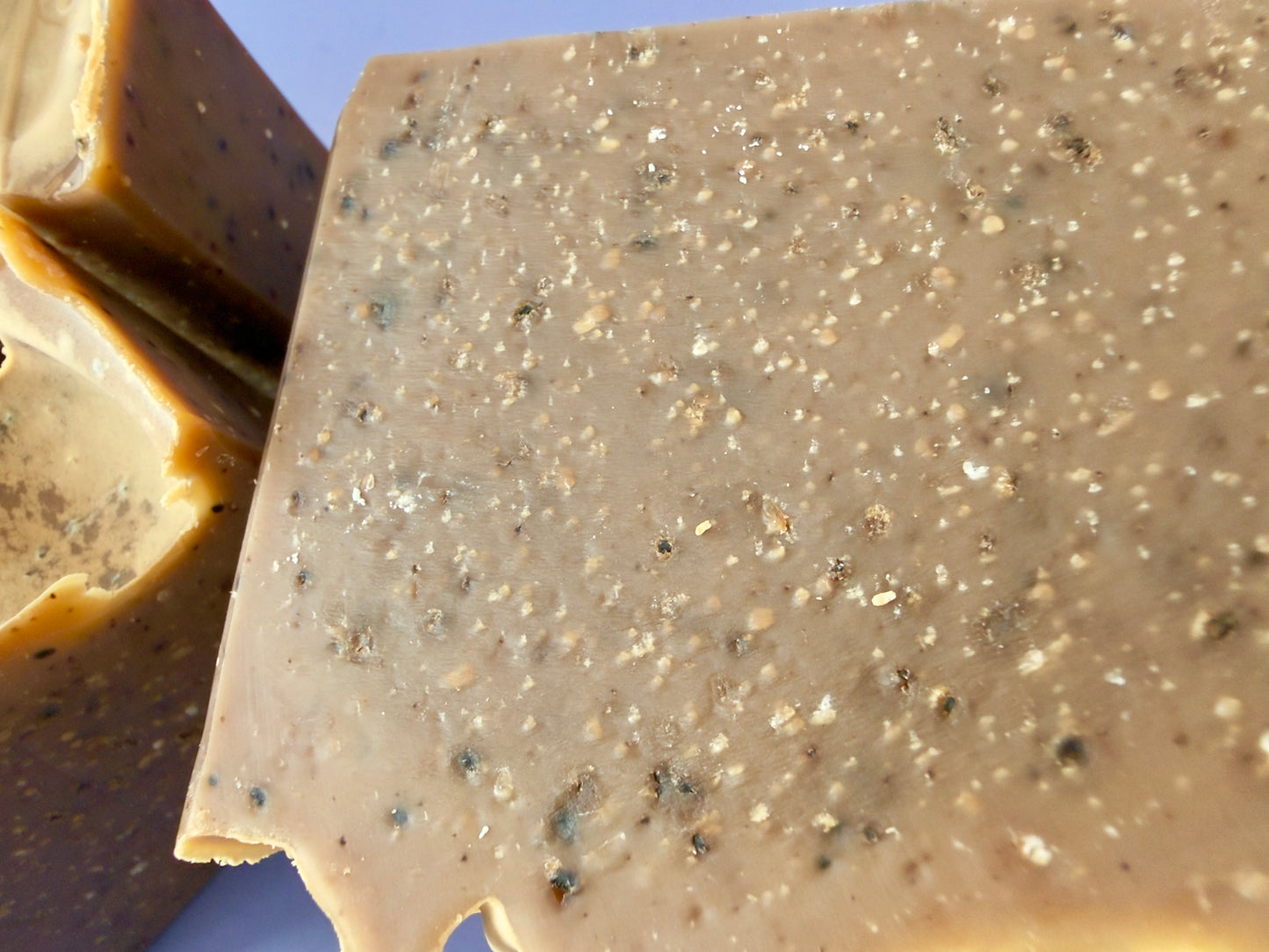 Close-up of coffee soap surface highlighting coffee grounds and salt speckling