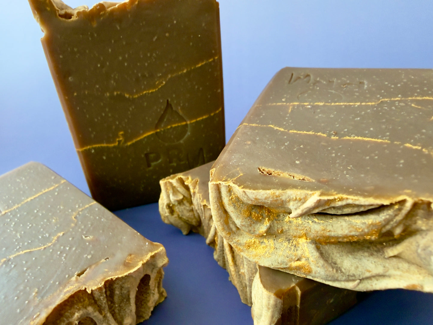 Close-up of soap surface highlighting gold veining and fine speckling