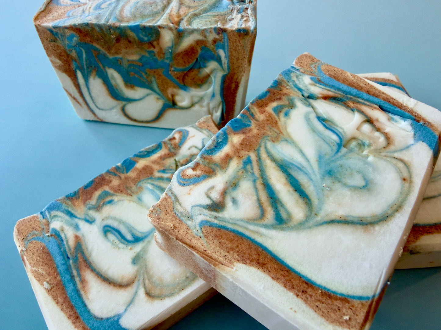 Handcrafted Citrus + Jasmine soap bar with PRM stamp and blue floral-style swirl.