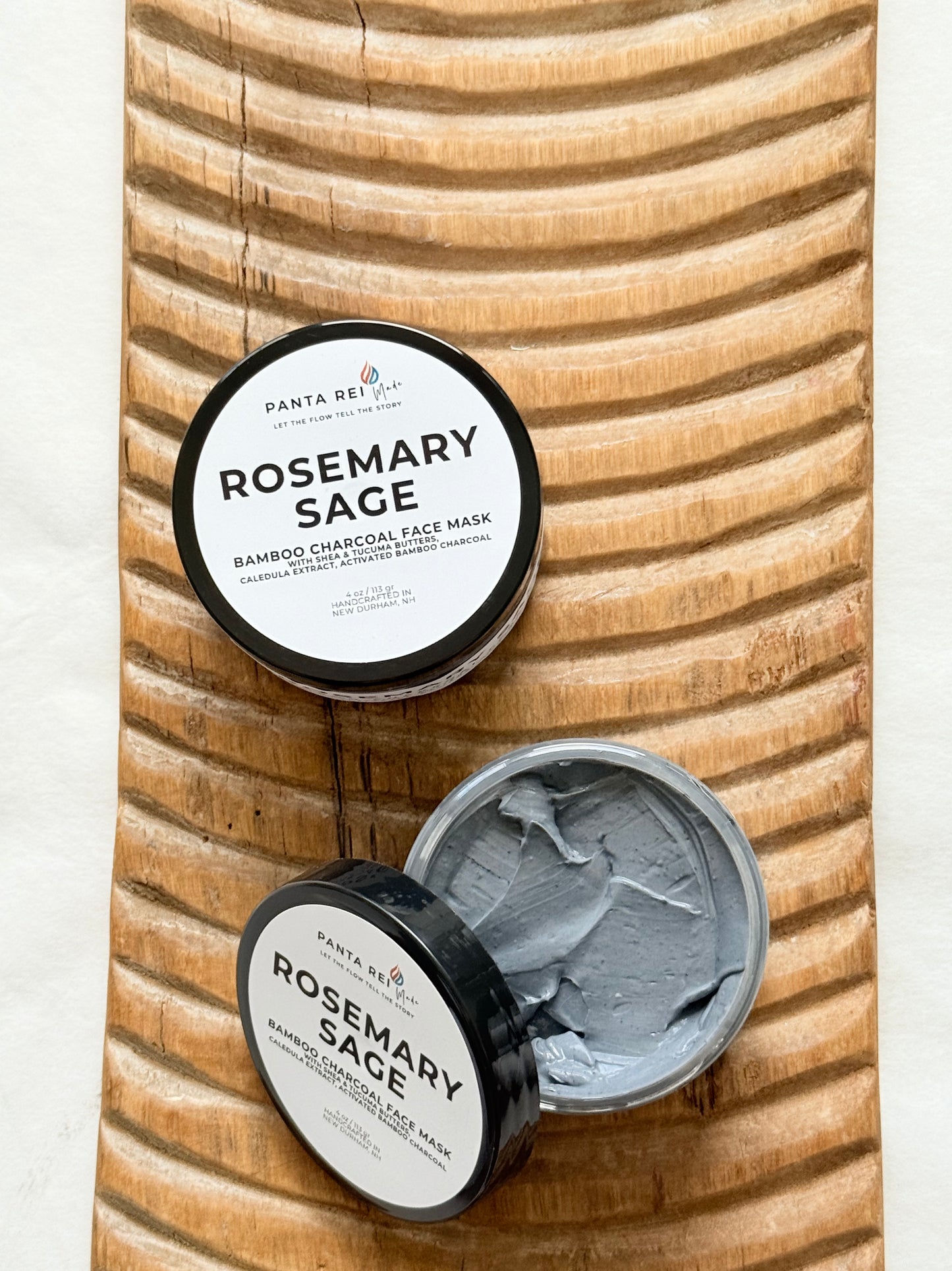 Open jar of Rosemary Sage charcoal face mask showing the smooth gray mask texture.