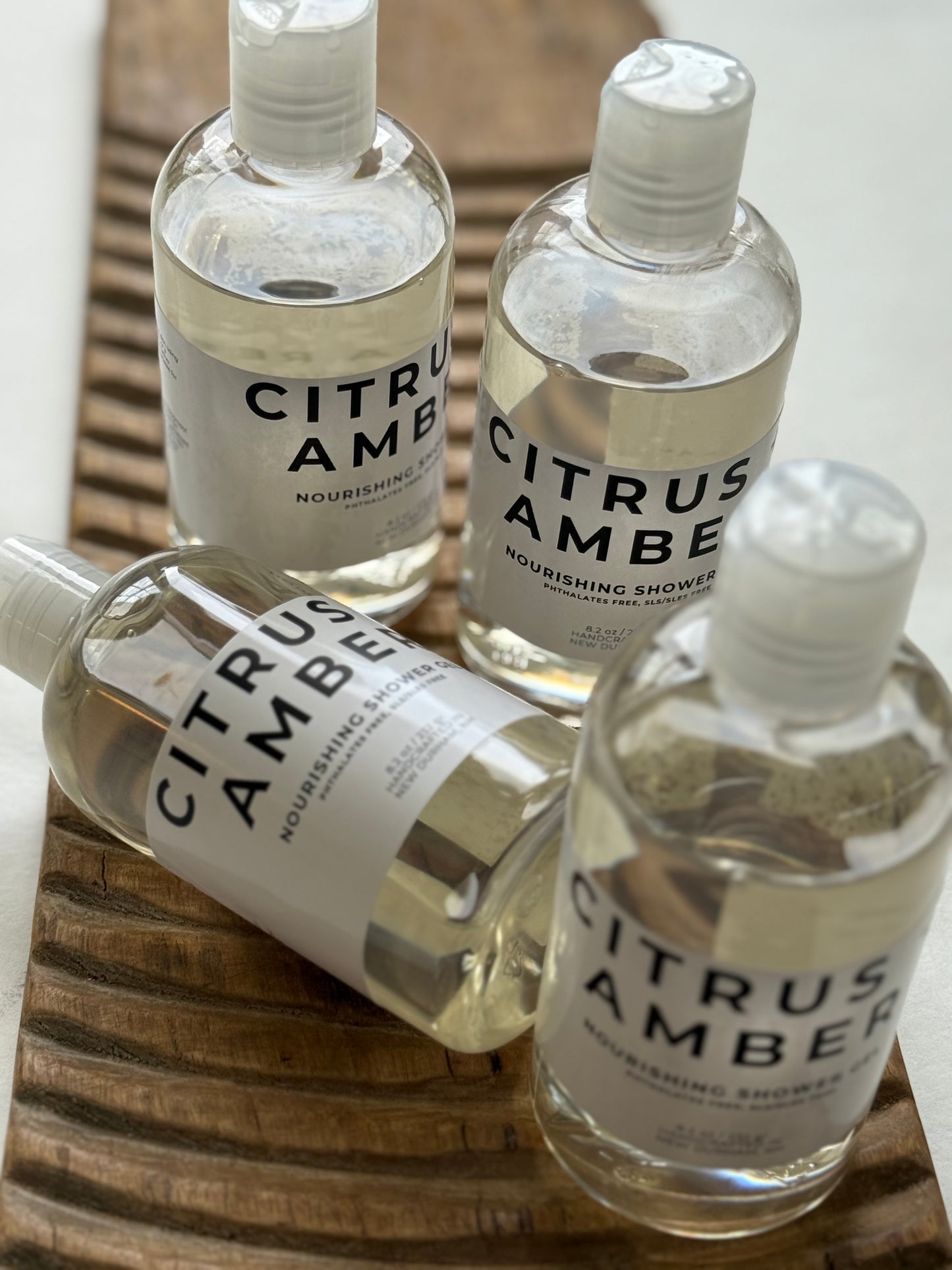 Panta Rei Made Citrus + Amber shower gel in clear bottles with white flip-top caps.