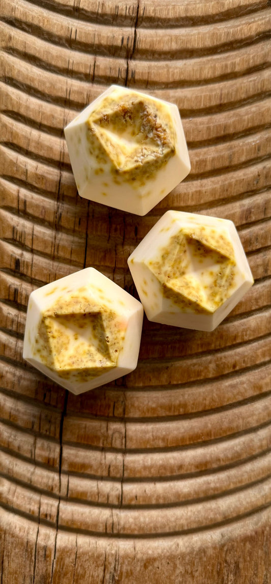 Hex-shaped camel milk soap bars with natural inclusions, showing that milk soaps can be visually textured and design-forward