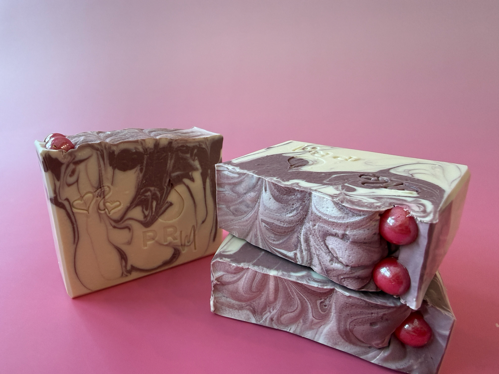 White Tea + Ginger small batch goat milk soap with a cream and mauve hanger swirl and red sugar pearl topping.