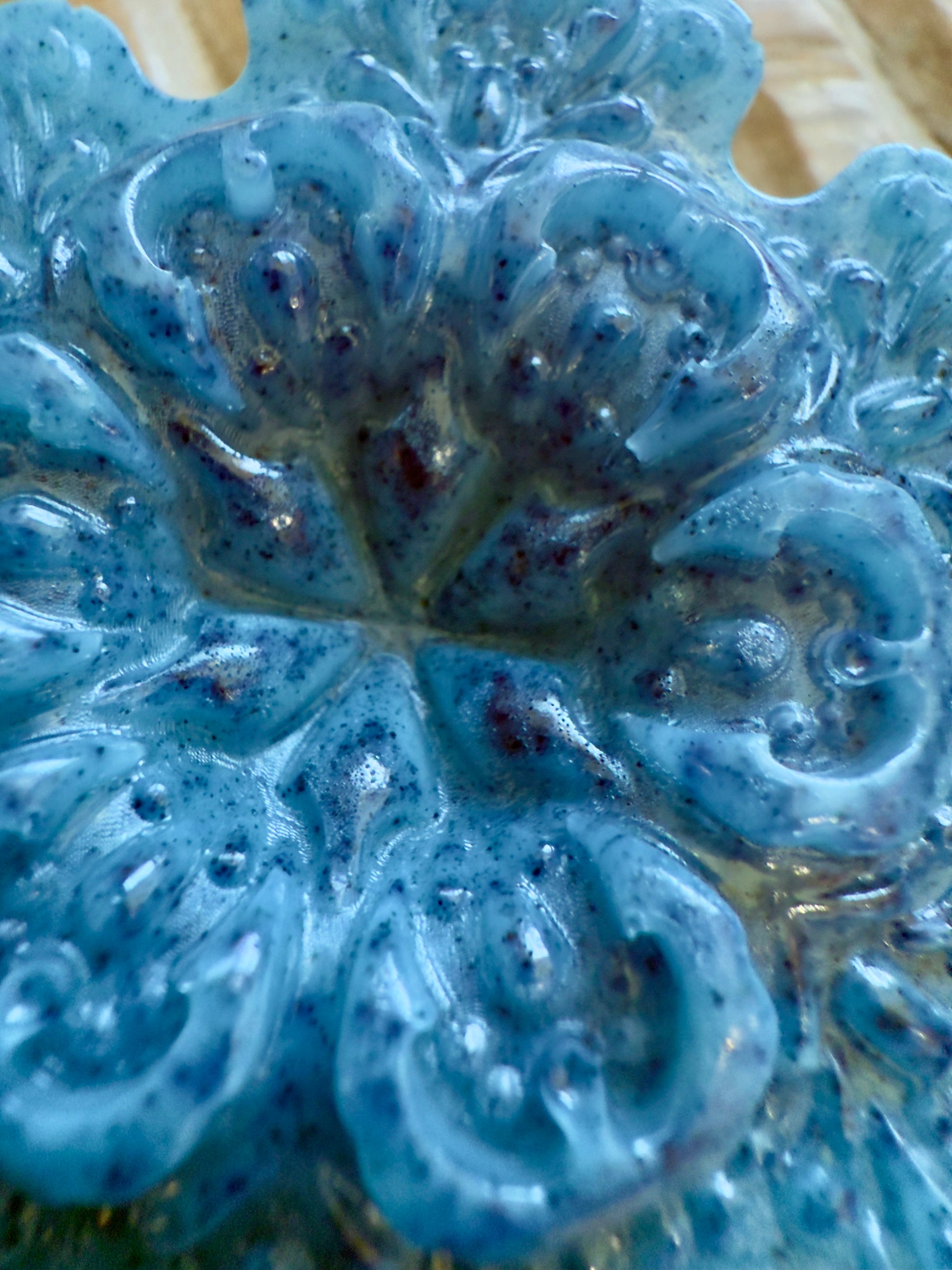 Blue snowflake goat milk soap with speckled detailing, sculpted pattern, and winter finish.