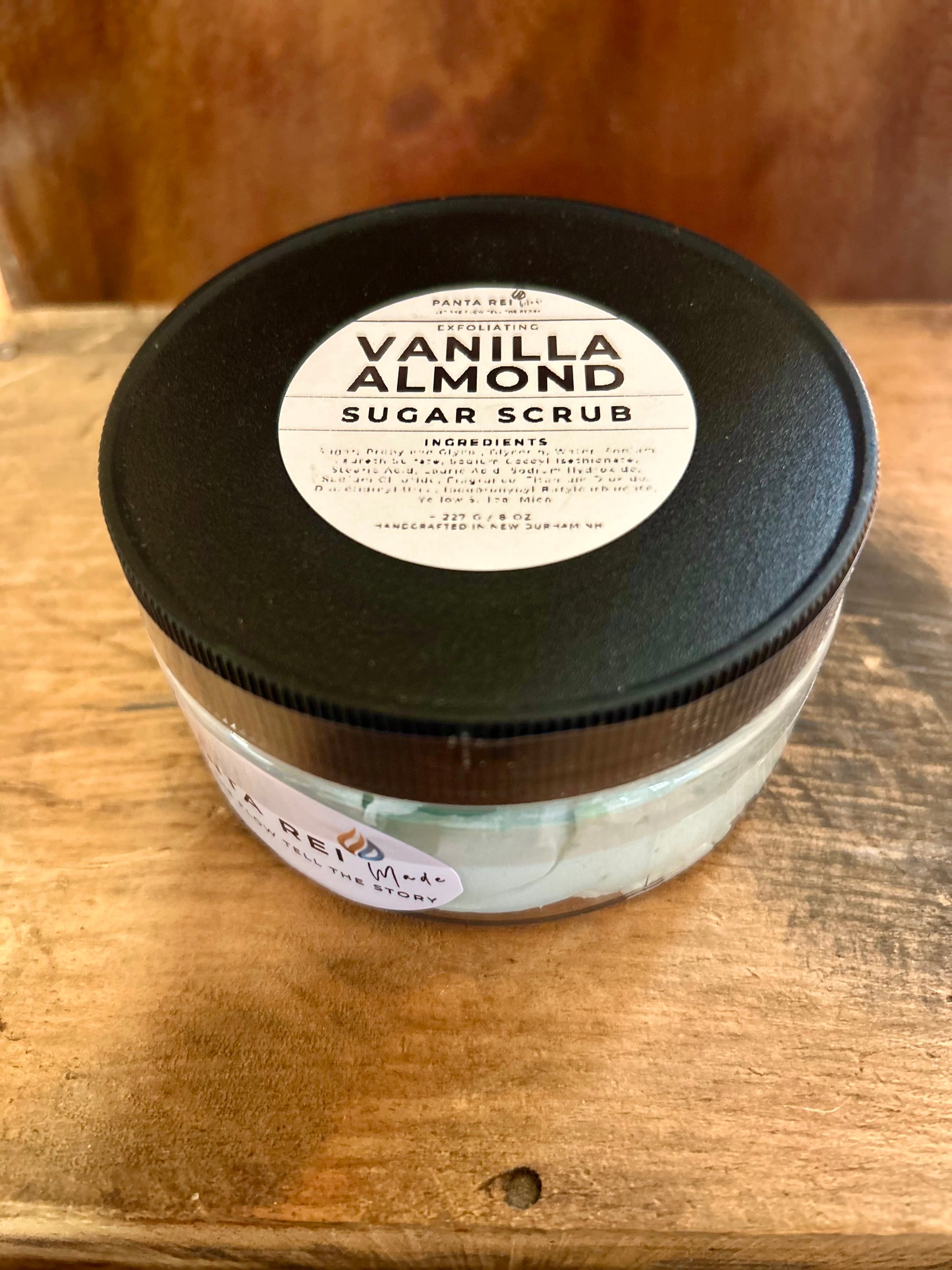 Jar of Vanilla Almond Sugar Scrub on a wooden surface
