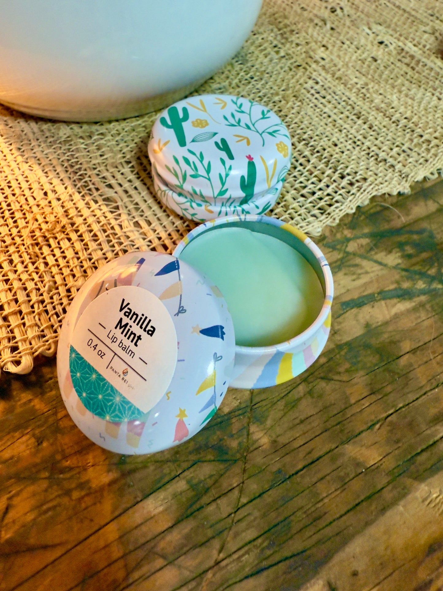 Vanilla Mint lip balm tin with pale green balm in decorative metal container