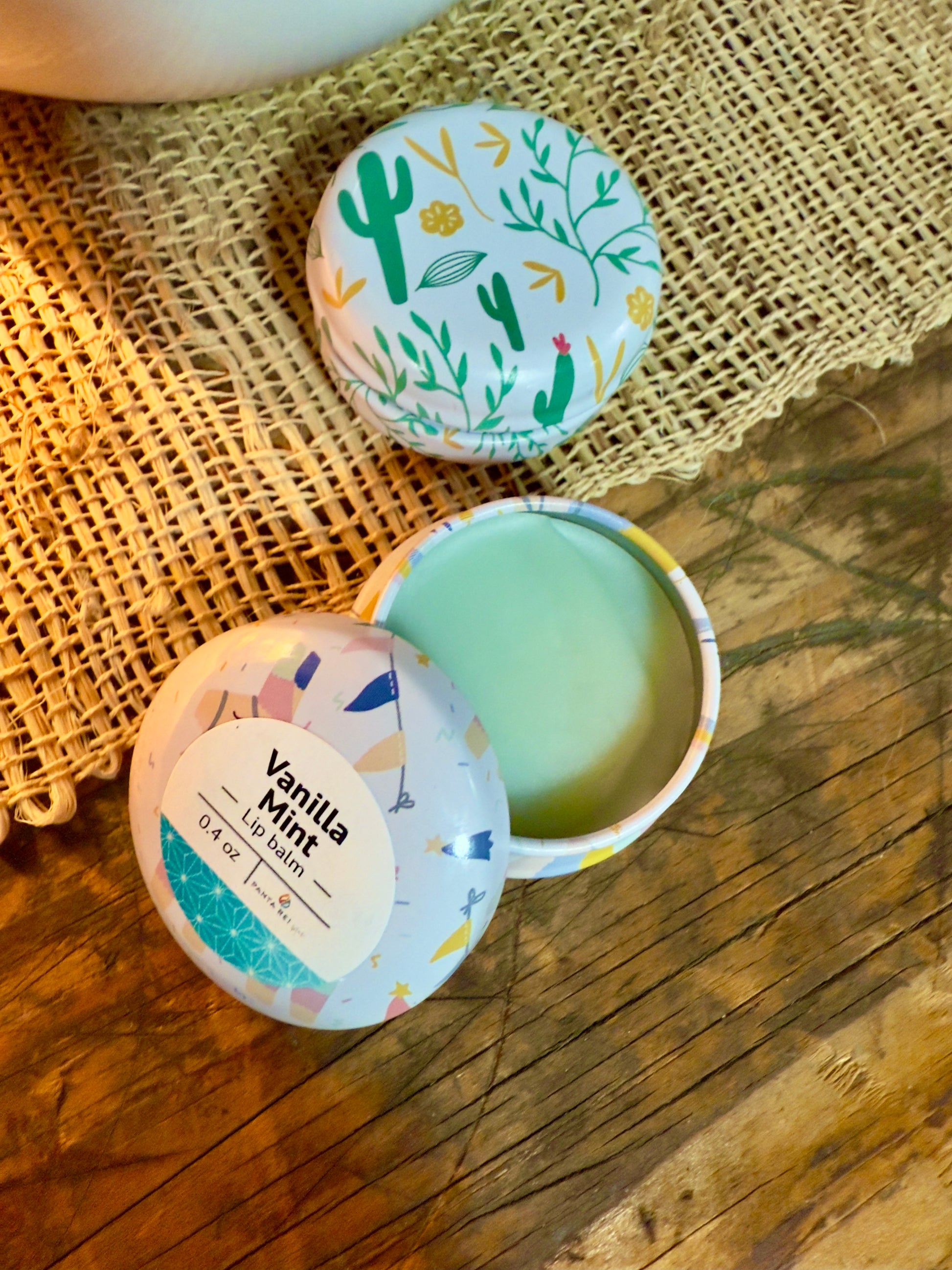 Vanilla Mint lip balm tin with pale green balm in decorative metal container