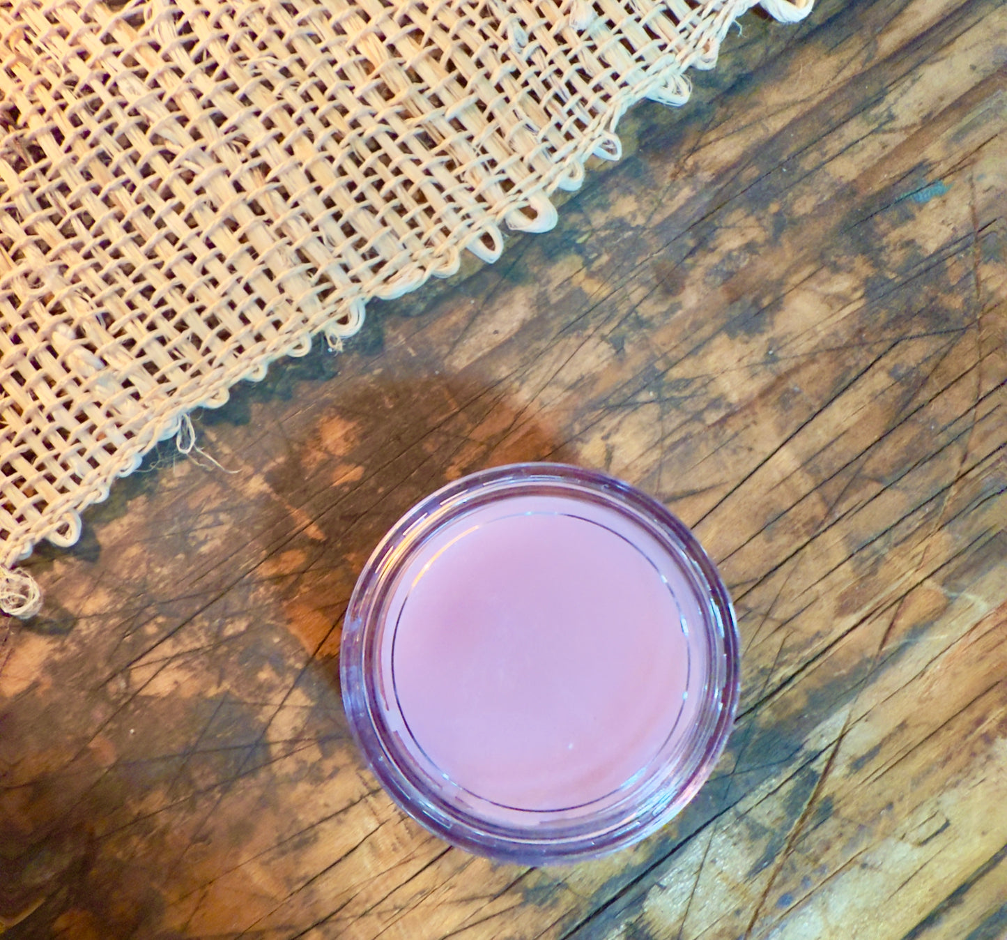 Passionfruit Rose Lip Butter in clear round pot with soft pink tint
