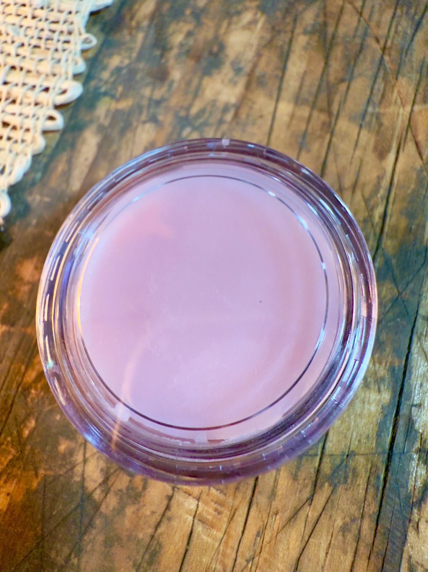 Passionfruit Rose Lip Butter in clear round pot with soft pink tint