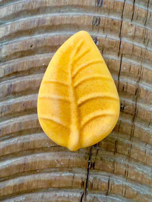 “Banana Pineapple solid shampoo bar in yellow leaf shape with subtle shimmer”