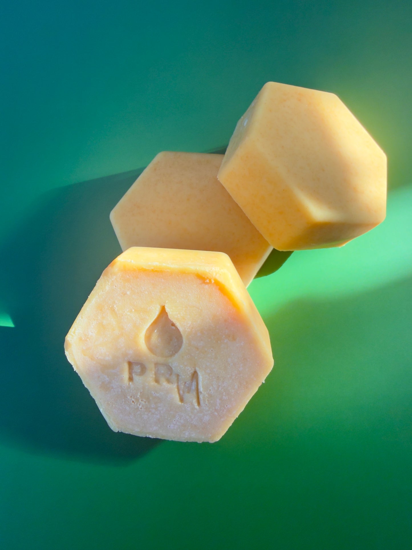 3 hexagon-shaped citrus soap bars with pale yellow tone and fine natural speckling
