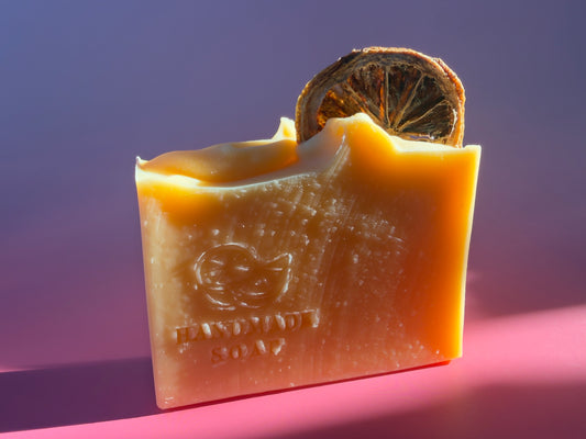 Beef tallow soap bar scented with pink grapefruit, topped with a dried orange slice