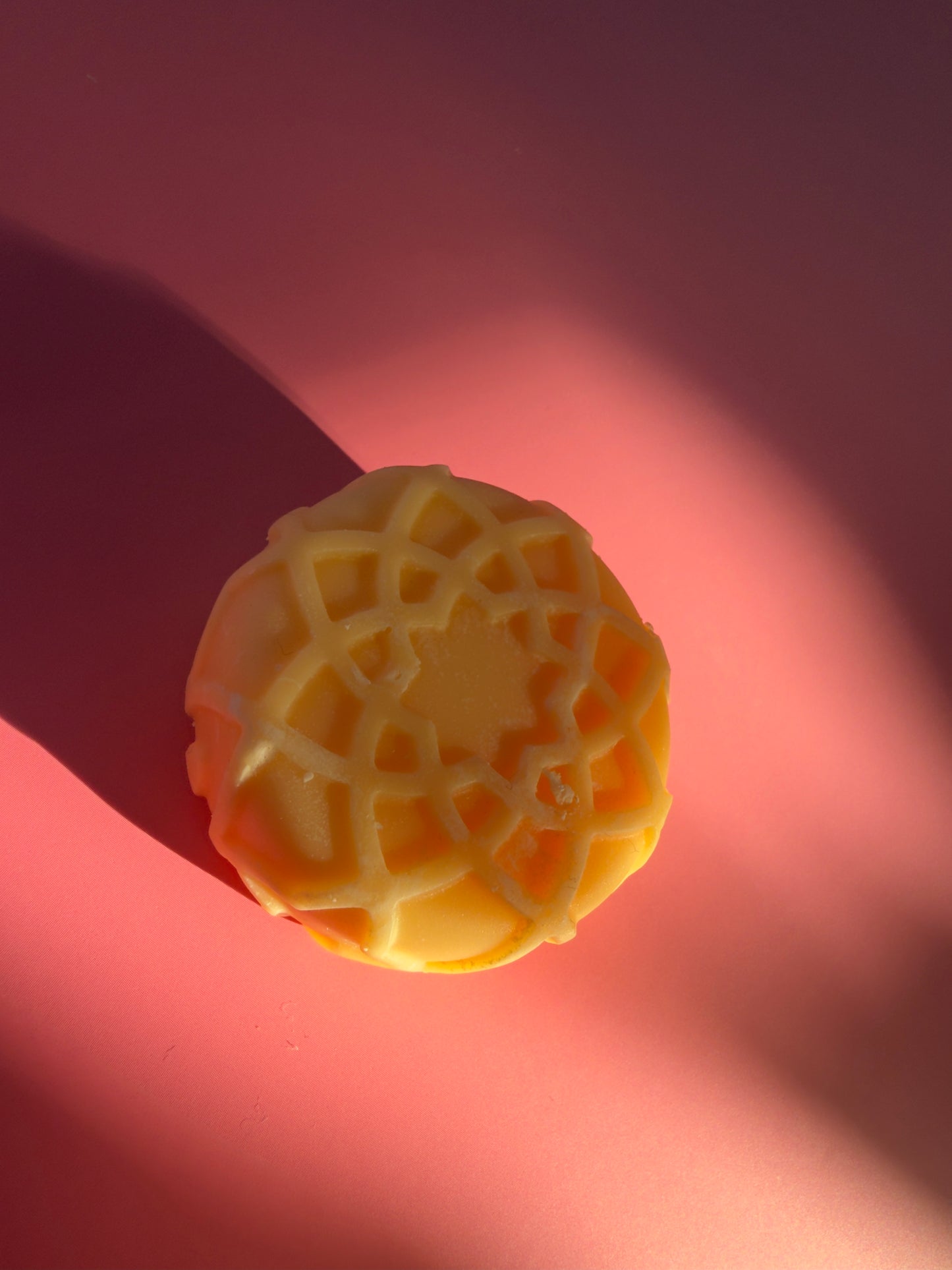 Round guest soap made with beef tallow and pink grapefruit essential oil