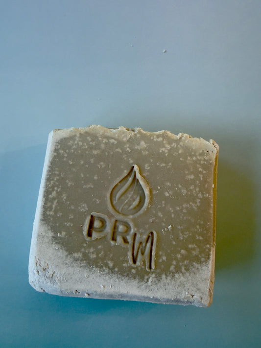 Square tallow soap bar with Cambrian blue clay and textured surface with a PRM logo