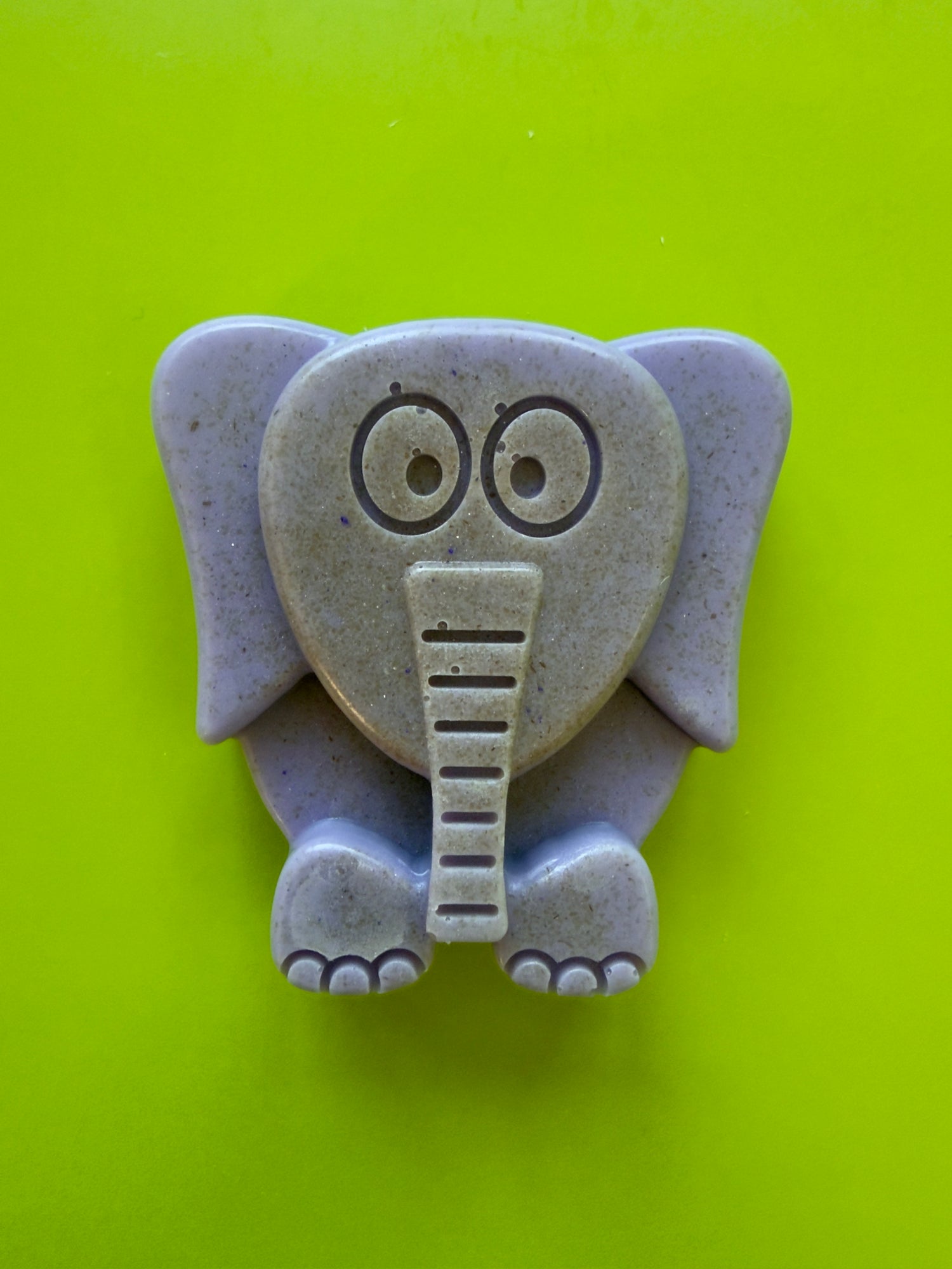 Purple elephant-shaped oatmeal soap with rounded edges and oat flecks