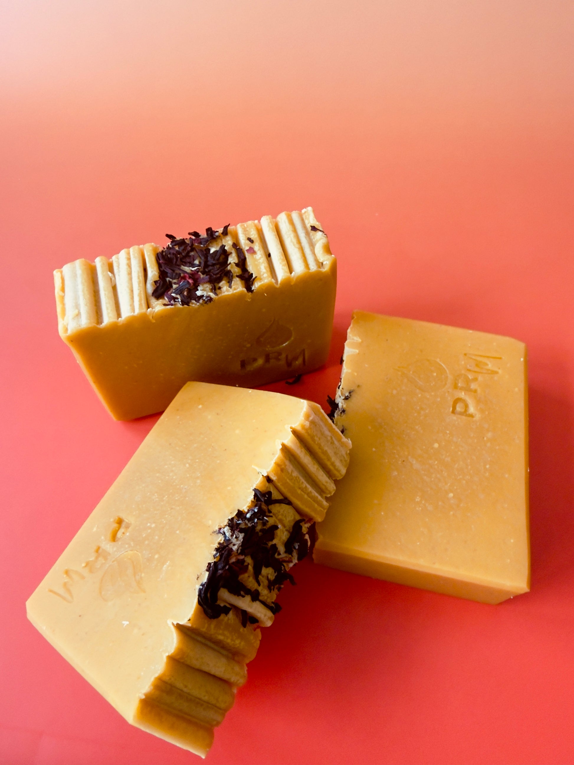Group of Apple Wisteria soap bars arranged together on gradient background, highlighting hand-cut edges
