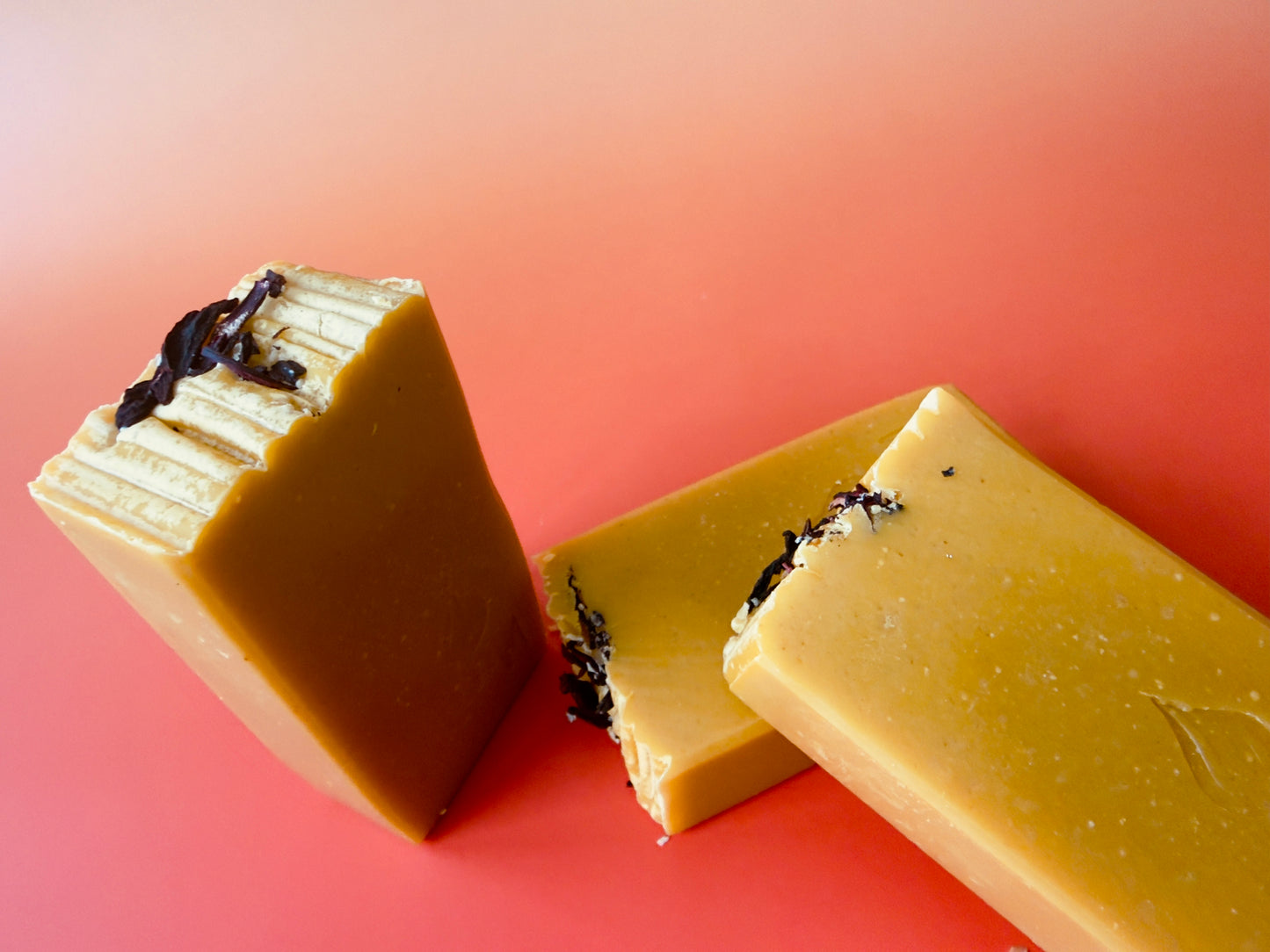 Three Apple Wisteria bars stacked and standing, showing loaf-cut shape and natural variation