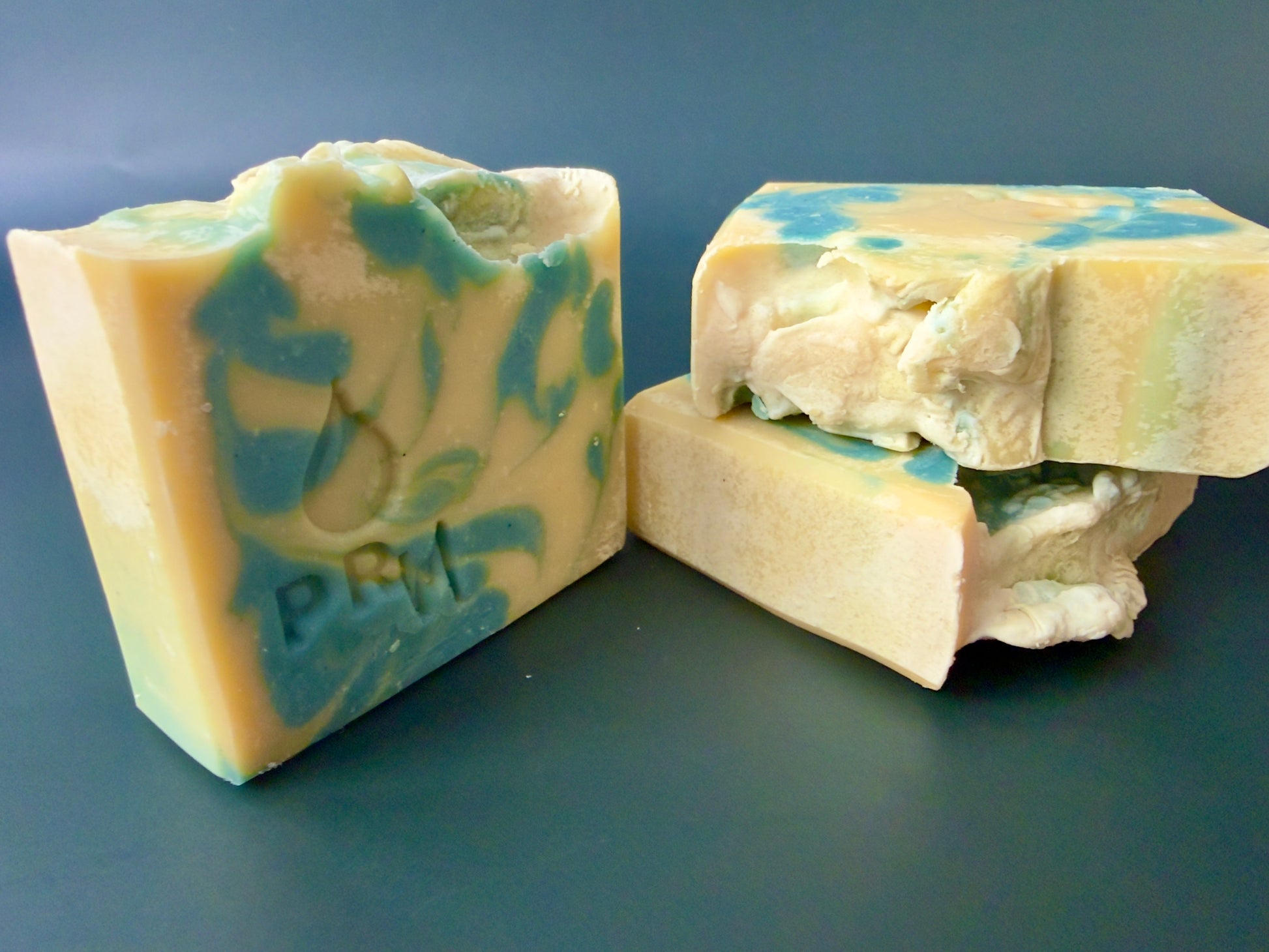 Three soap bars stacked to show marbled interior and textured top