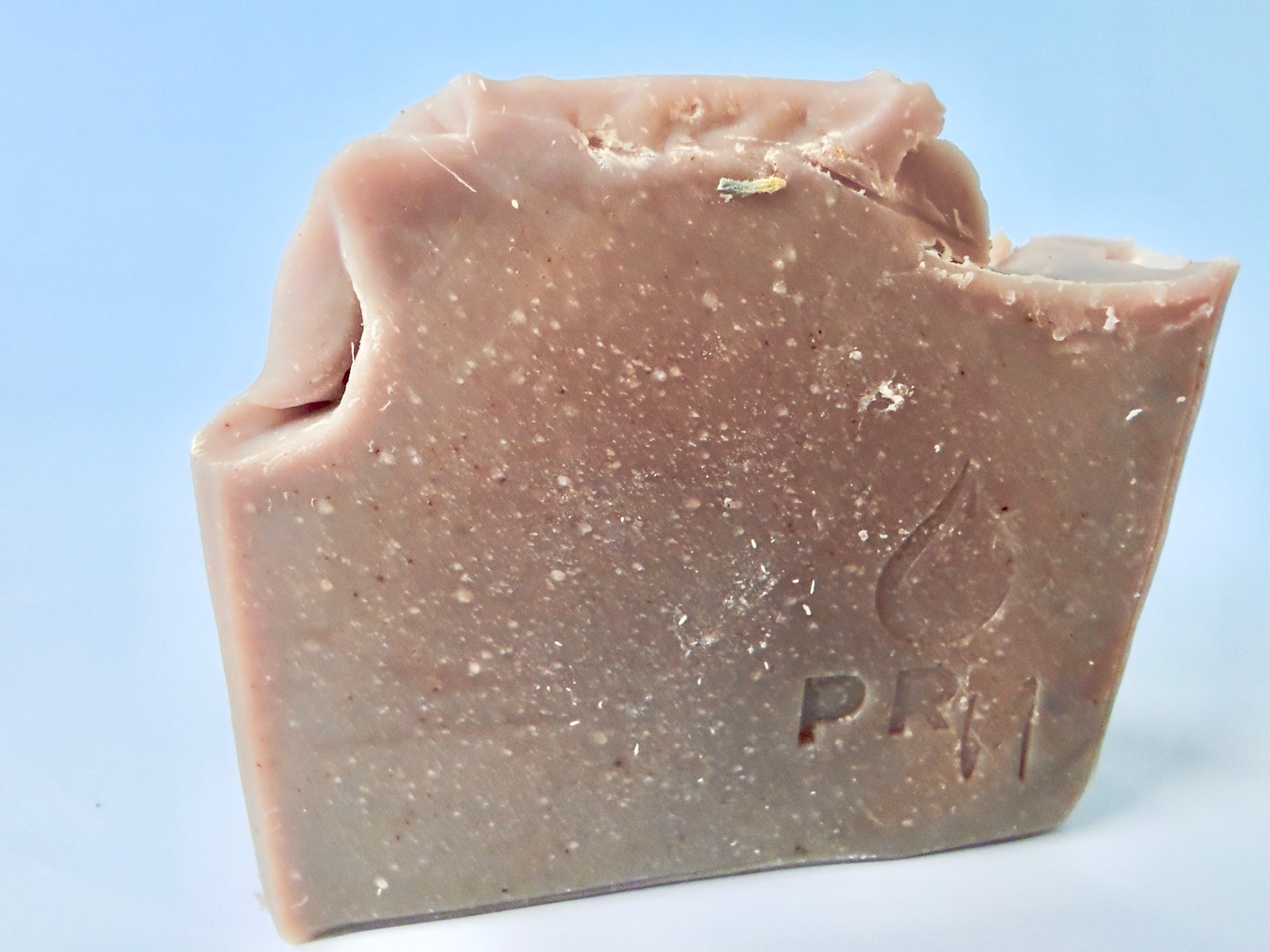 Rectangular loaf-cut soap bar in muted purple-brown tones with PRM stamp