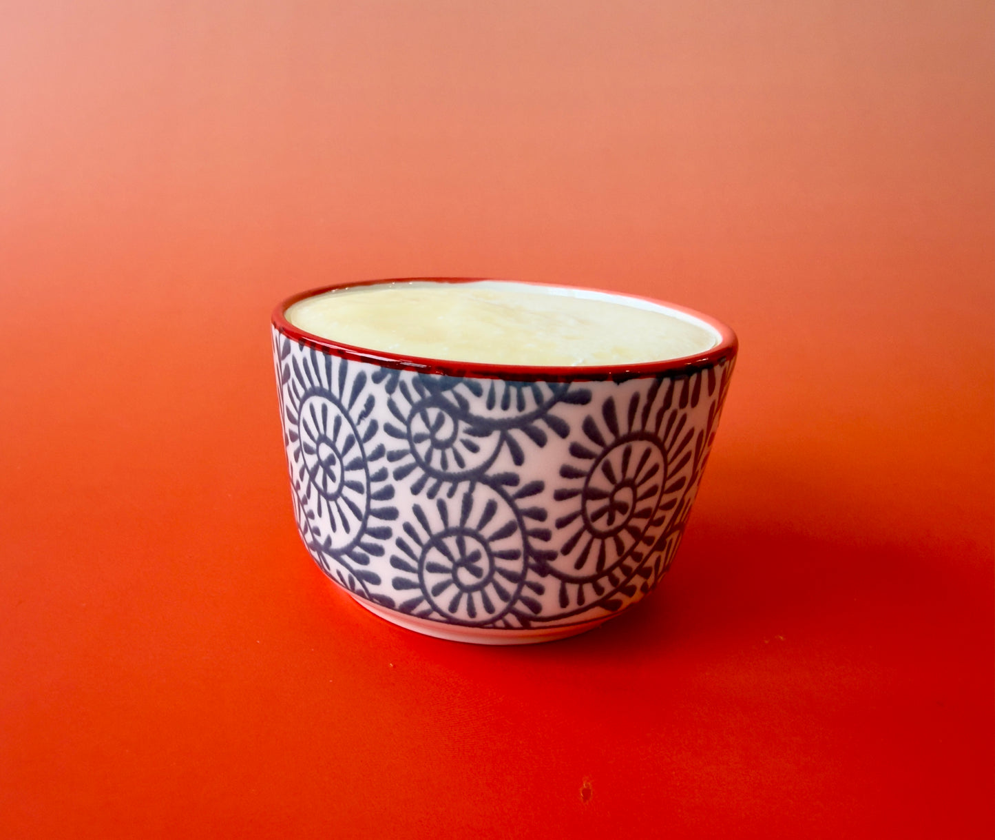 Single ramekin shown from the side, highlighting smooth soap surface and decorative ceramic pattern