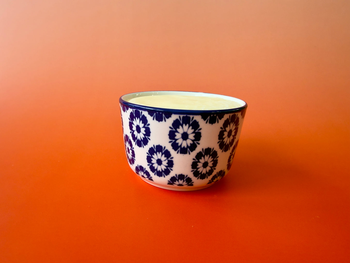 Single ramekin shown from the side, highlighting smooth soap surface and decorative ceramic pattern