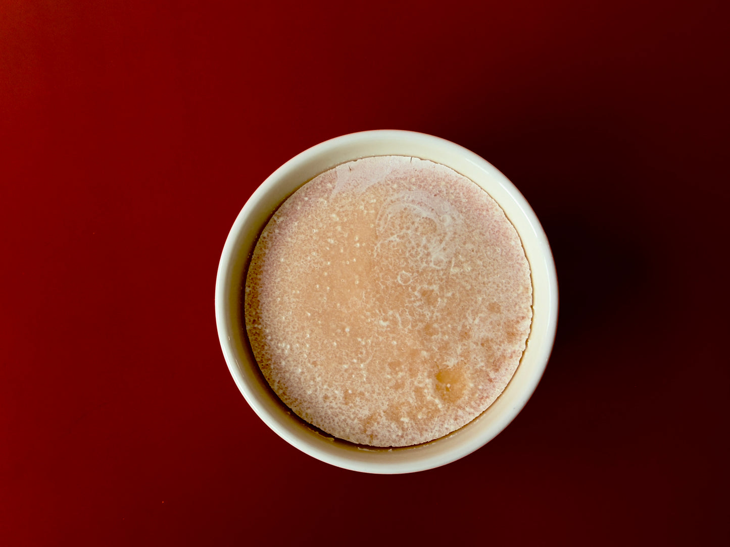 Close-up of solid dish soap surface inside reusable ceramic ramekin