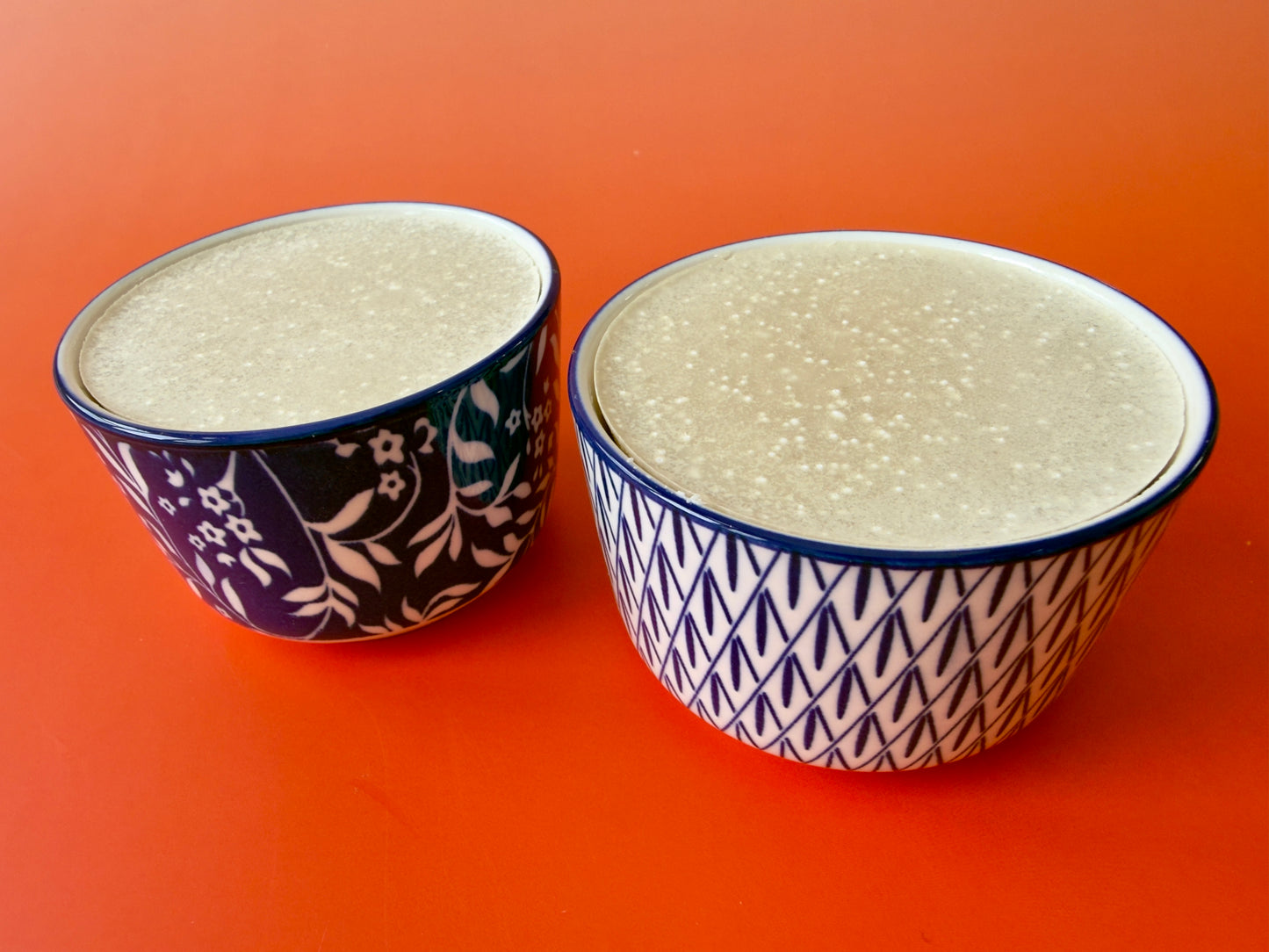 Two solid dish soaps in contrasting blue-and-white ramekins side by side