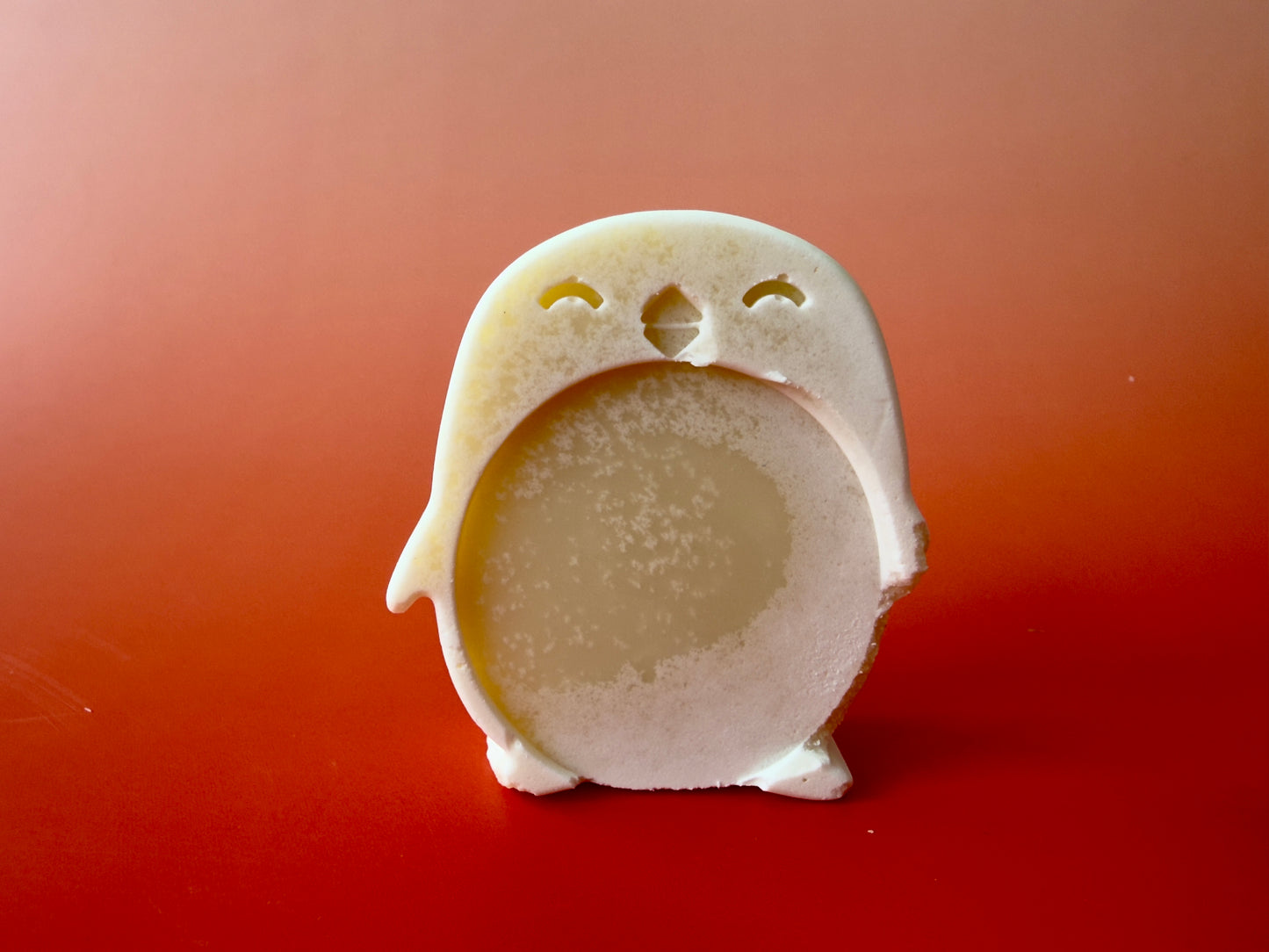 Fragrance-free baby soap shaped like a penguin with a rounded belly