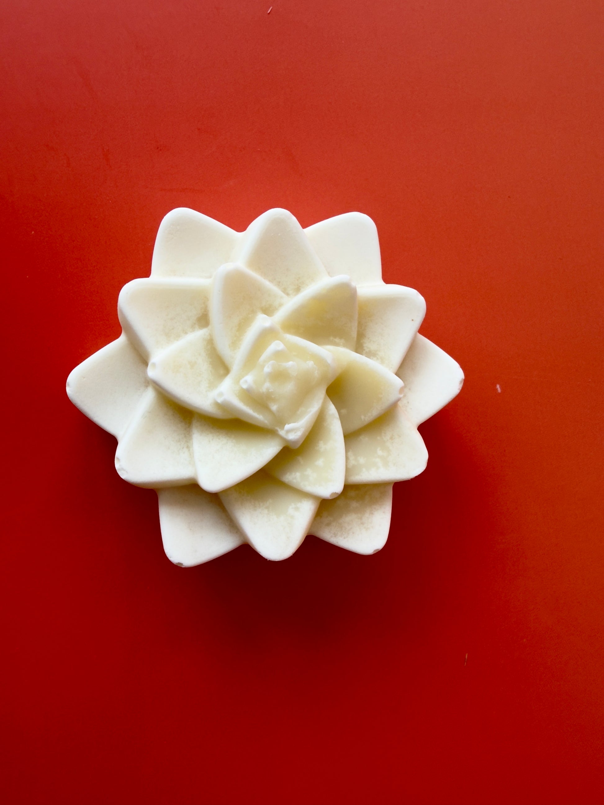 Unscented baby soap molded as a layered flower with soft petal details