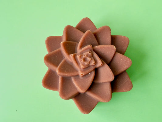 Shea butter baby soap molded as a layered flower with a warm clay tone