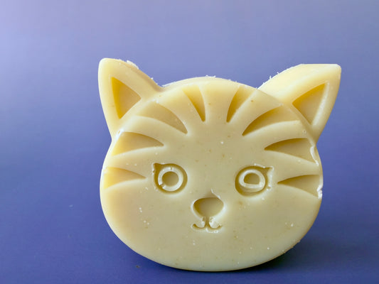 Chamomile baby soap shaped like a cat face with soft yellow tone