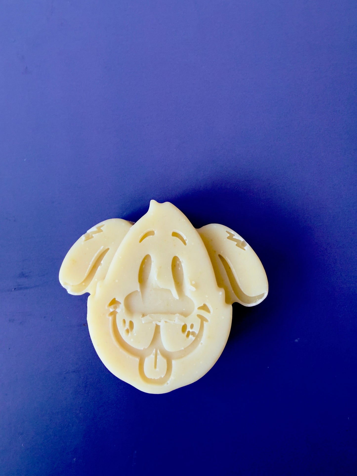 Gentle baby soap shaped like a puppy face with rounded features