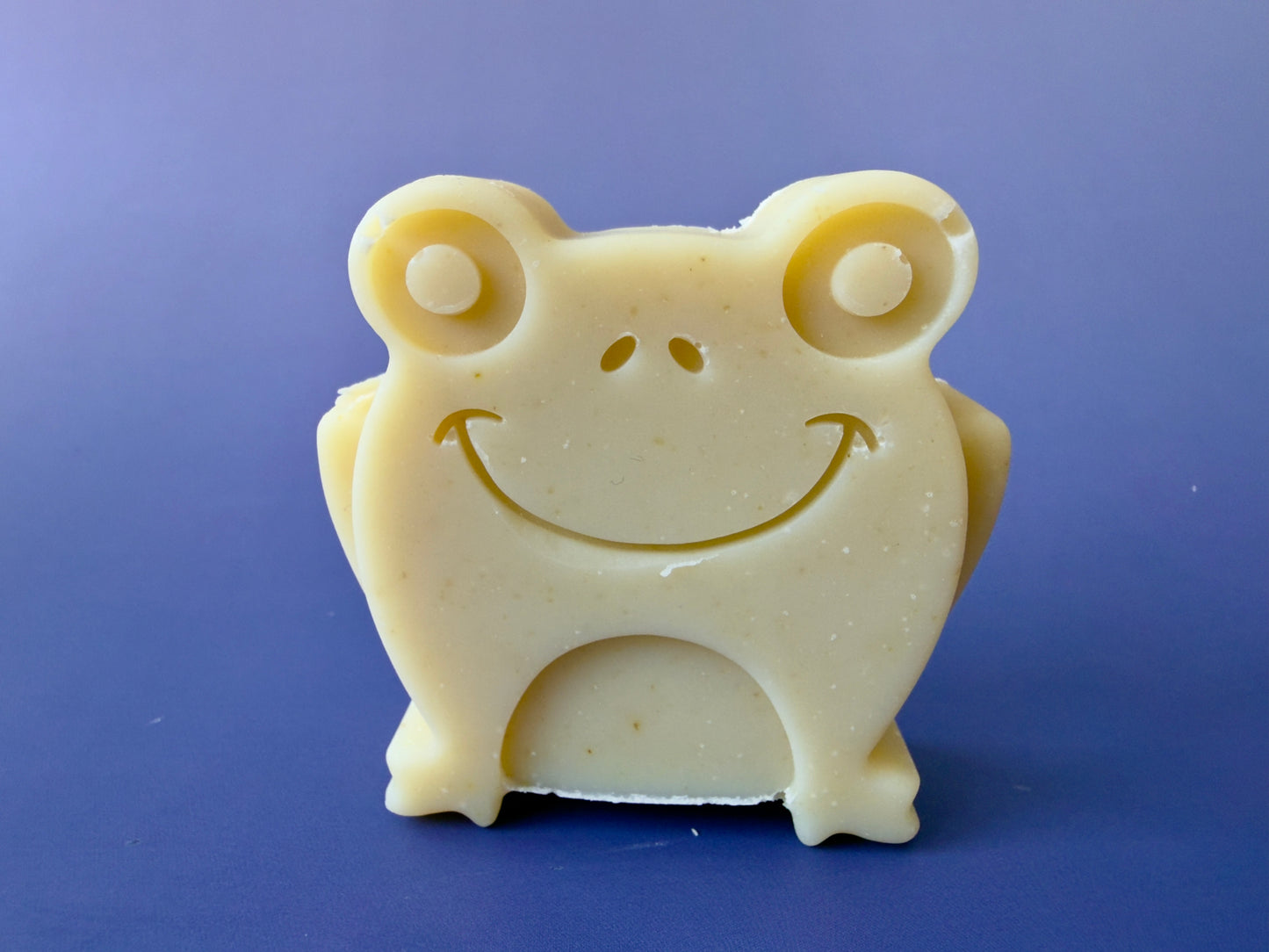 Shea butter baby soap shaped like a smiling frog with smooth edges