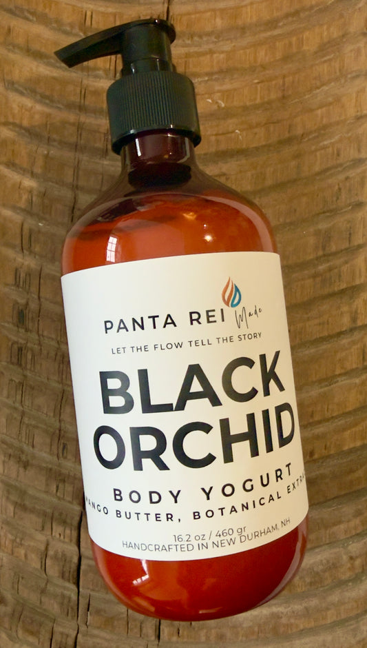 Amber pump bottle of Black Orchid body yogurt with minimalist Panta Rei Made label on wood surface