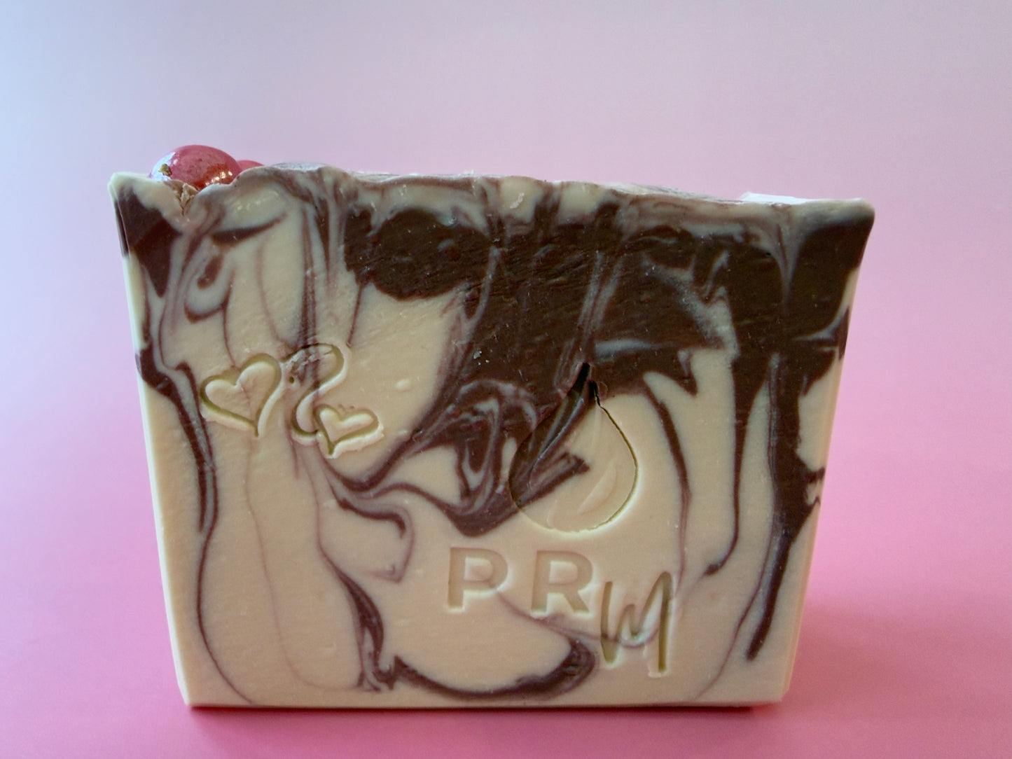 Handcrafted White Tea + Ginger goat milk soap bar with PRM stamp and swirl design.