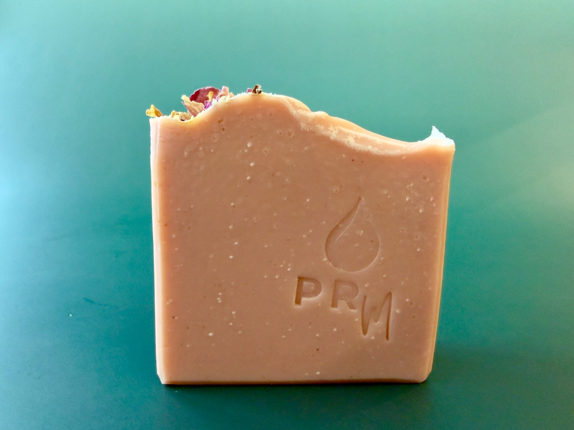 Mandarin Lavender small batch aloe soap with soft pink color and rose petals on top.