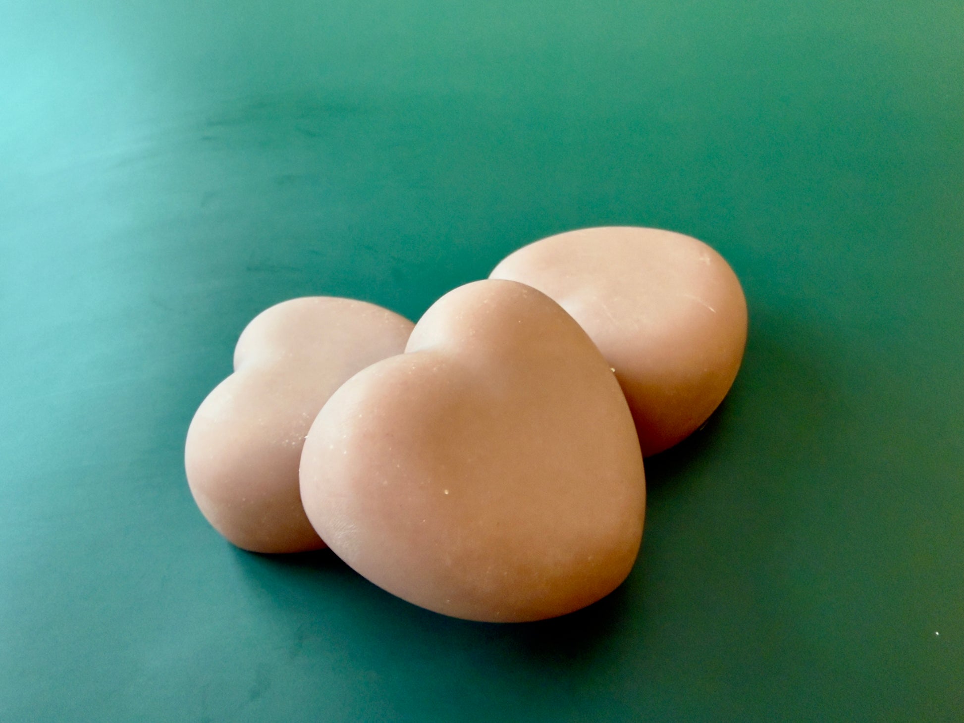 Handcrafted Tea Rose + Bergamot heart-shaped soap made with goat milk and kaolin clay.