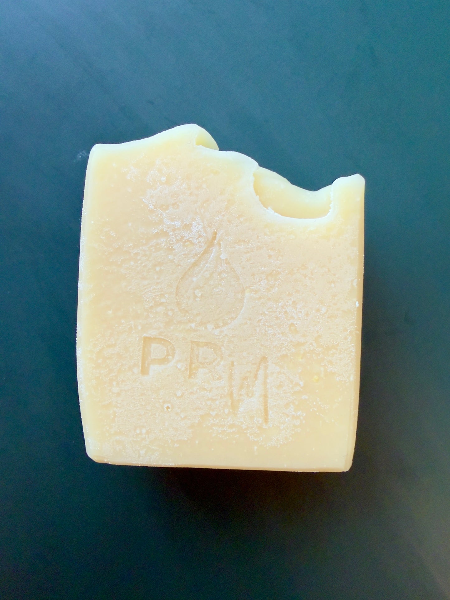 Handcrafted Lavender Orange goat milk soap with a cream-colored finish and simple textured top.