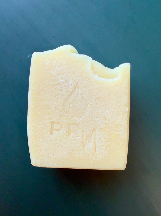 Handcrafted Lavender Orange goat milk soap with a cream-colored finish and simple textured top.