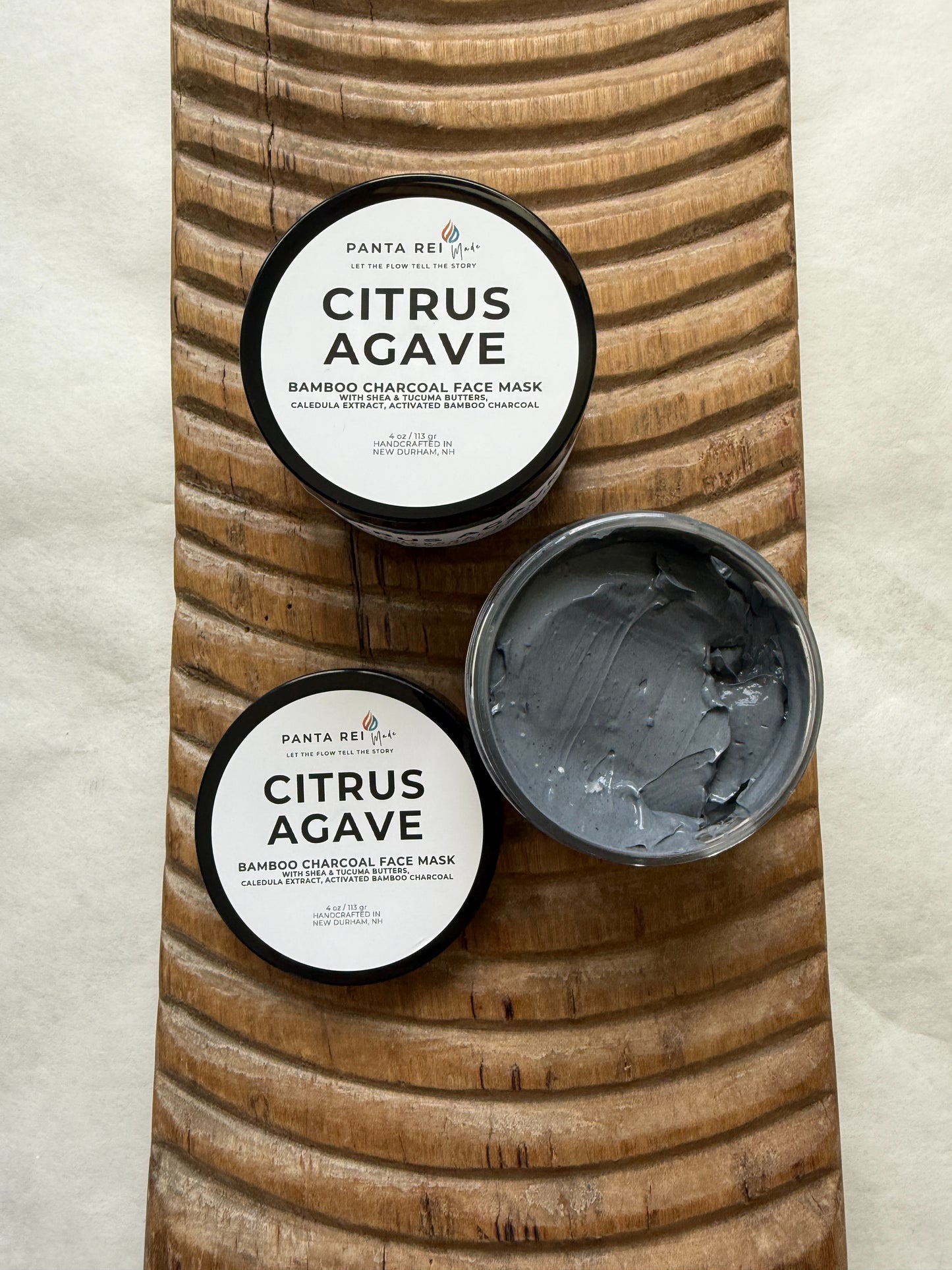 Open jar of Citrus Agave face mask showing the smooth gray charcoal mask texture.