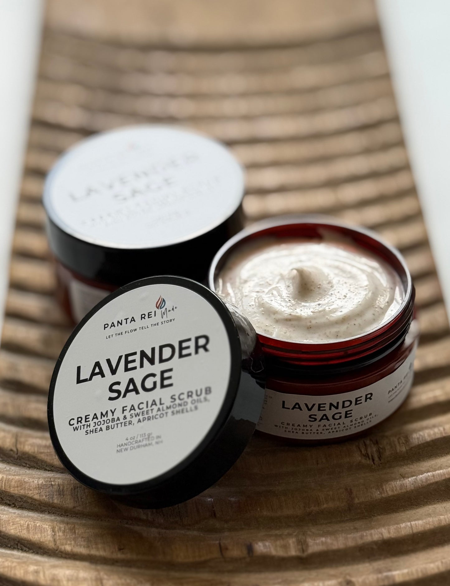 Open jar of Lavender Sage facial scrub showing the creamy exfoliating texture.