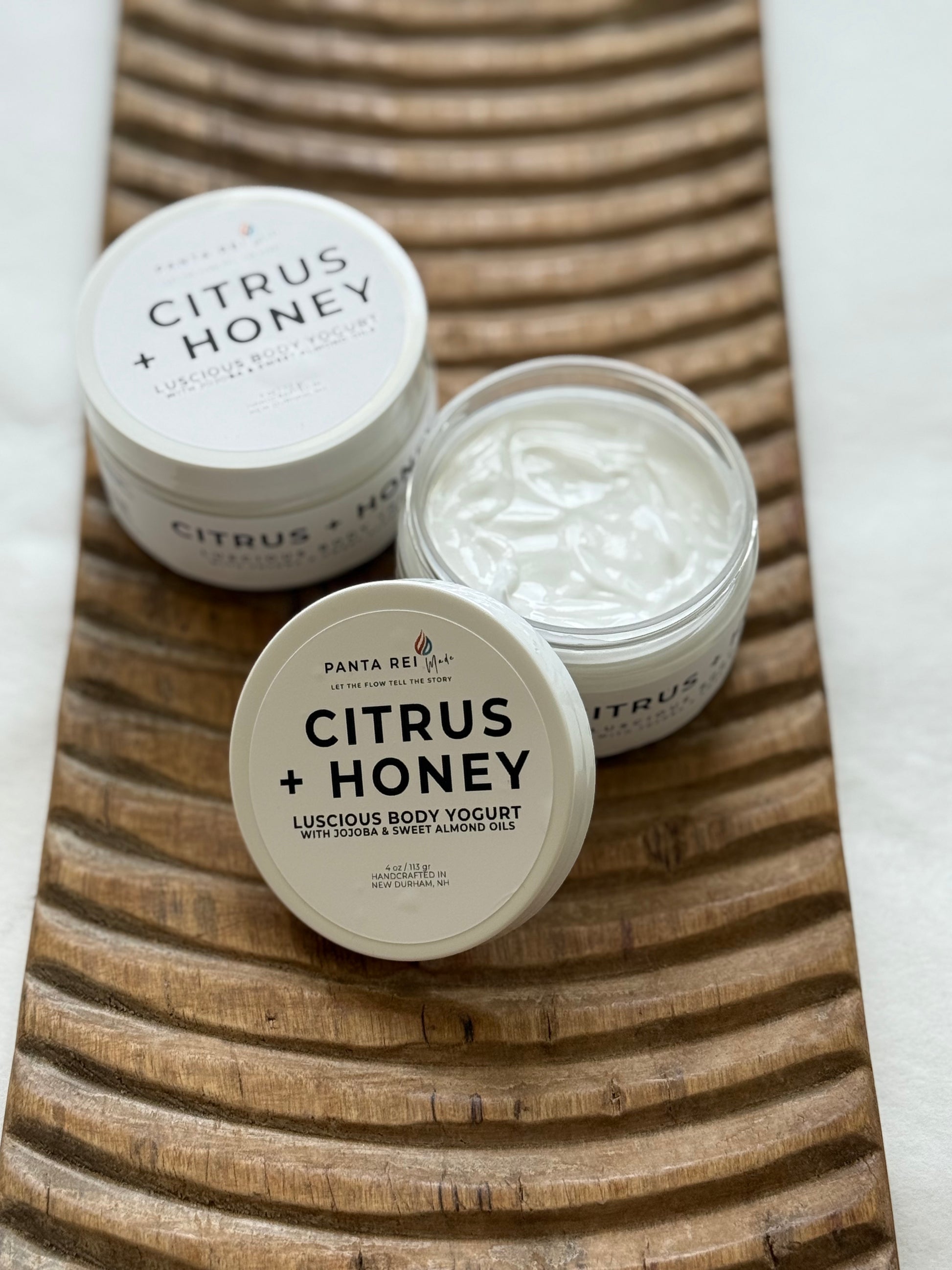 Open jar of Citrus + Honey body yogurt showing the smooth creamy texture.