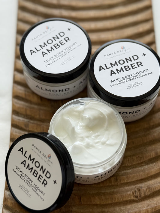 Open jar of Almond + Amber body yogurt showing the smooth creamy texture.