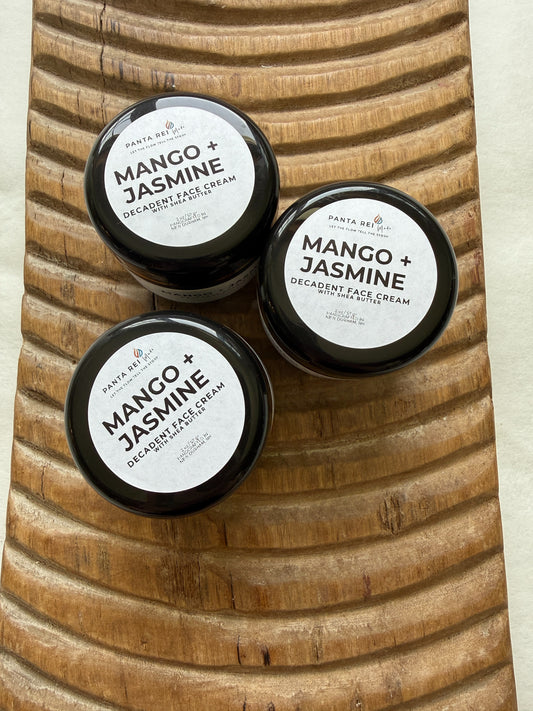 Three jars of Mango + Jasmine Decadent Face Cream on a wooden surface