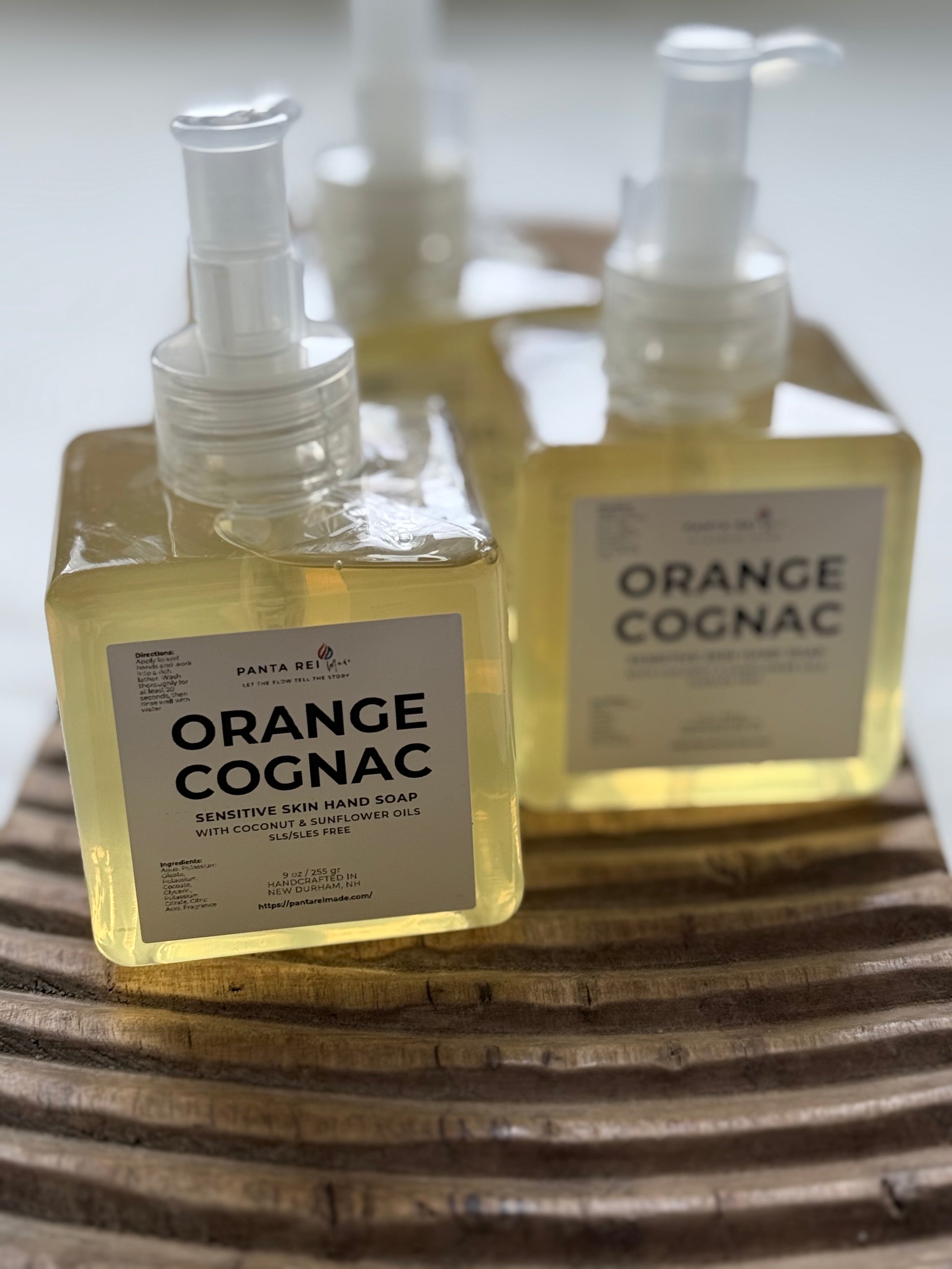 Orange Cognac sensitive skin hand soap in clear square pump bottles.