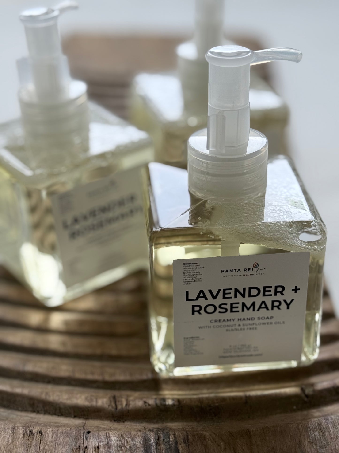 Panta Rei Made Lavender + Rosemary liquid hand soap with white pump tops.